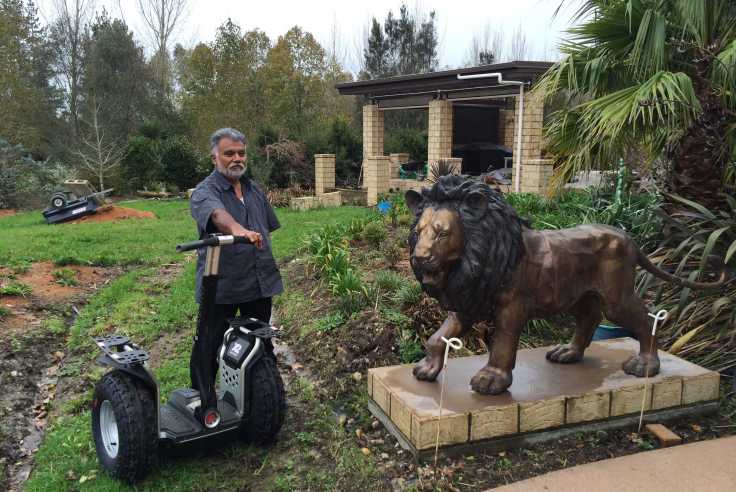 Rohit and his Segway x2, along with one of his two lions that guard his home